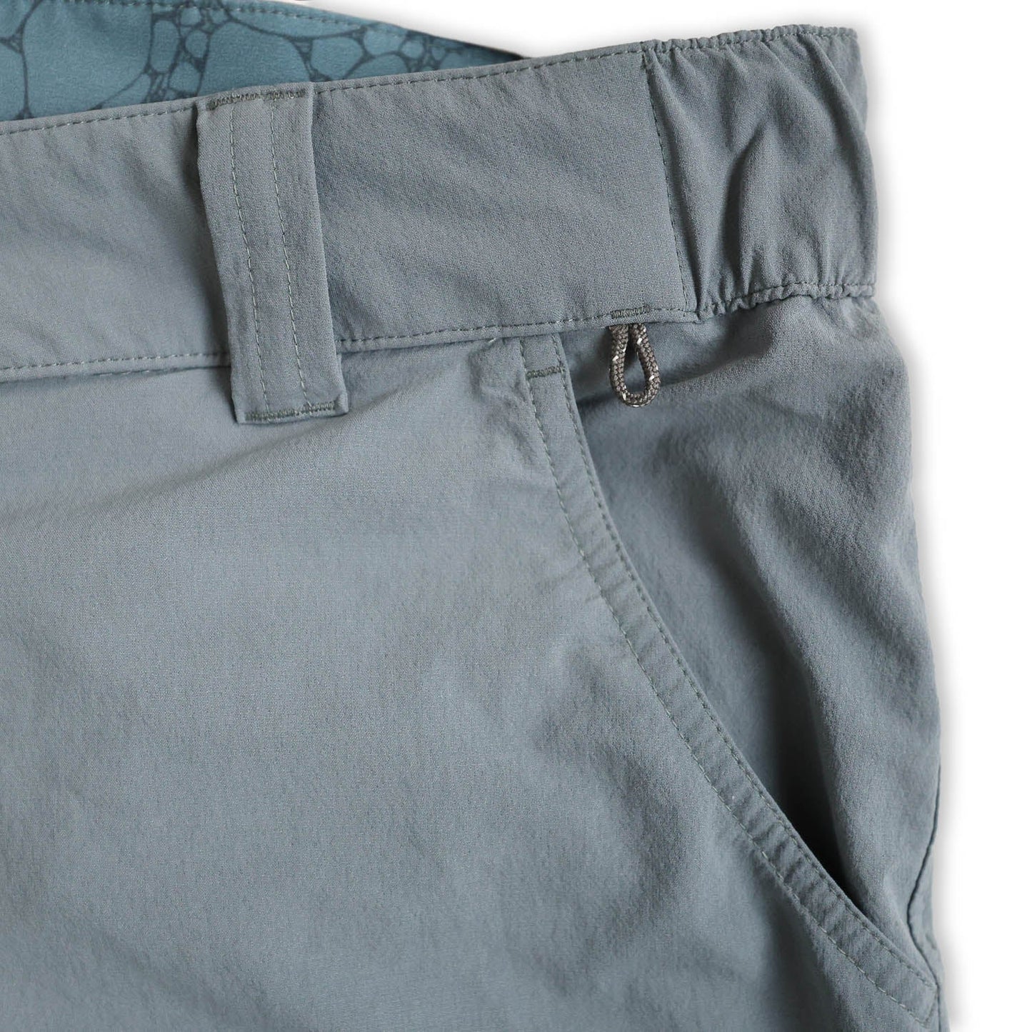 Close-up of light blue pants pocket with a white background