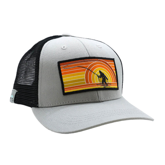 gray hat with black mesh back with a patch on the front showing sasquatch casting a fly rod and retro orange and yellow shades in the background