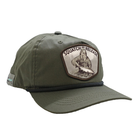 A green hat with a black rope featuring a design showing sasquatch releasing a fish that says squatch and release