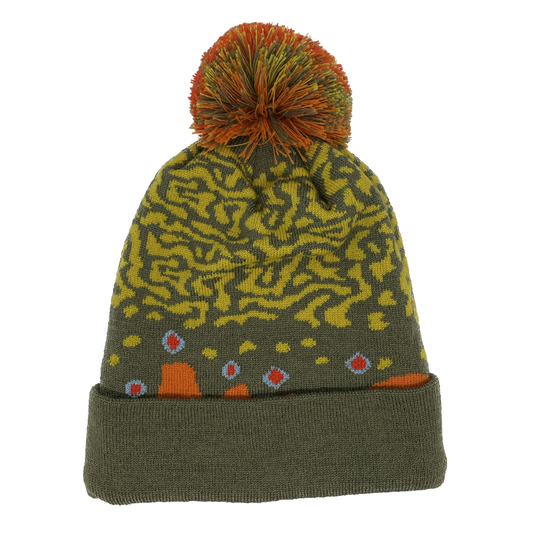 A winter hat imitating brook trout skin with a red and green poof on top and a green cuff