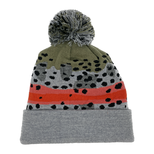 A winter hat imitating rainbow trout skin with a gray and green poof on top and a light grey cuff